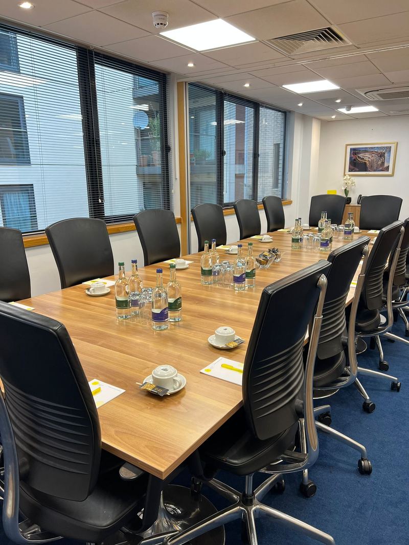 A meeting room at Regal Court Business Centre in Slough, set out with a long table and chairs.