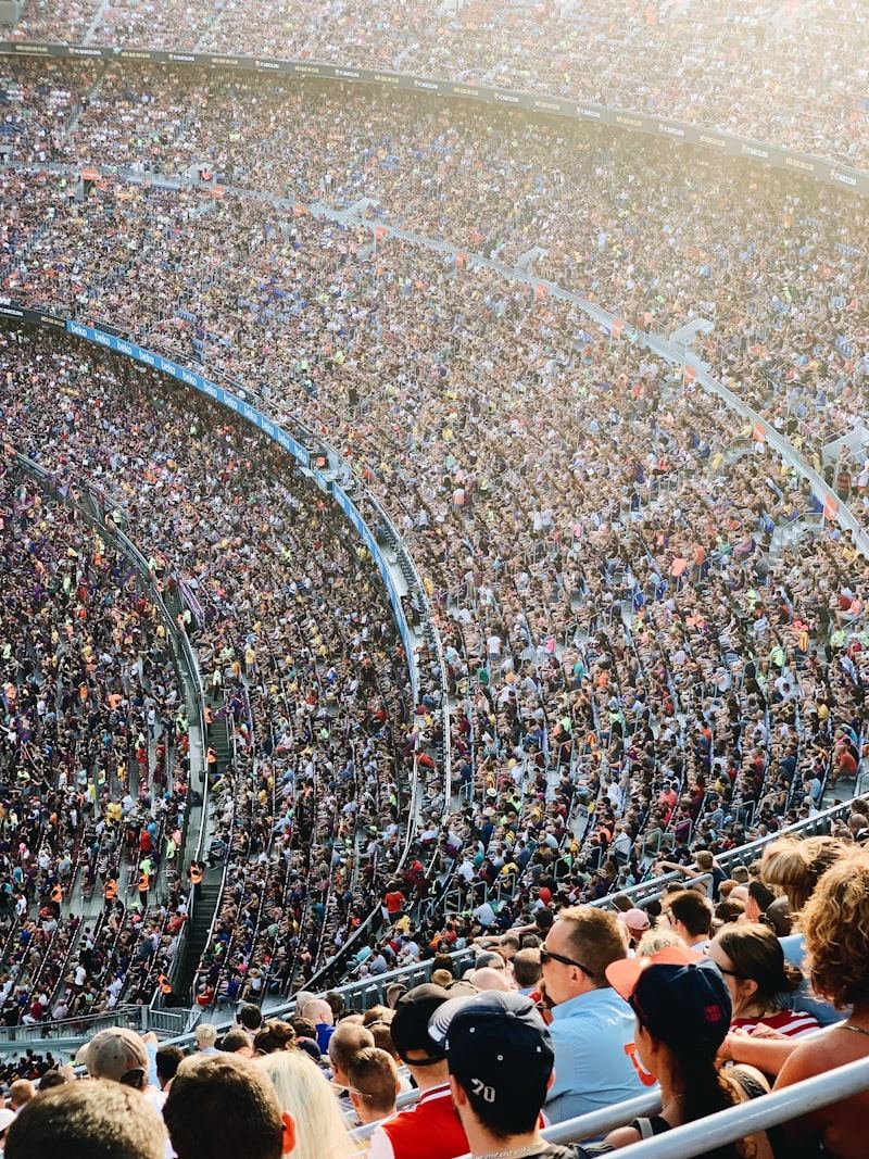 A packed stand at a stadium, seen from above, with every seat taken.